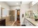 Bathroom featuring a glass shower, double mirrors, and walk in closet at 2964 Via Della Amore, Henderson, NV 89052