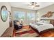 Bedroom with ceiling fan, hardwood floors, and windows with coverings at 2964 Via Della Amore, Henderson, NV 89052
