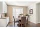 Breakfast nook with a round table and chairs, surrounded by white cabinets and natural light at 2964 Via Della Amore, Henderson, NV 89052