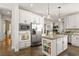 Open kitchen with stainless steel appliances, white cabinetry, and a functional island for meal preparation at 2964 Via Della Amore, Henderson, NV 89052