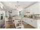 Bright kitchen featuring white cabinetry, an island with a granite countertop, and stainless steel appliances at 2964 Via Della Amore, Henderson, NV 89052