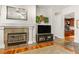 Living room with a fireplace and media center. Adjacent to a separate den/office space at 2964 Via Della Amore, Henderson, NV 89052
