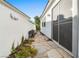 Beautiful landscaped side yard with a stone pathway and decorative wall art, offering serene outdoor space at 2964 Via Della Amore, Henderson, NV 89052