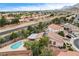 Aerial shot featuring a home with a backyard pool, carport, and solar panels in a residential neighborhood at 3200 Ridgecliff St, Las Vegas, NV 89129