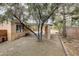 Backyard featuring a covered patio, gravel landscaping, and lush trees at 3200 Ridgecliff St, Las Vegas, NV 89129