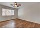 This bedroom boasts laminate flooring, a ceiling fan, and a large window allowing for an abundance of natural light at 3200 Ridgecliff St, Las Vegas, NV 89129