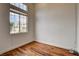 A room with light walls, wood-look floors, a large window letting in natural light, and baseboard trim at 3200 Ridgecliff St, Las Vegas, NV 89129