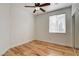 This bedroom boasts laminate flooring, a ceiling fan, a window for natural light, and a sliding door closet at 3200 Ridgecliff St, Las Vegas, NV 89129