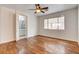 A spacious bedroom with wood floors, a ceiling fan, and a bathroom entrance at 3200 Ridgecliff St, Las Vegas, NV 89129
