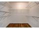 Walk in closet with wood floor and metal shelving installed on all walls at 3200 Ridgecliff St, Las Vegas, NV 89129