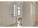 Bright home entryway featuring white walls, and a glimpse of a room with wood floors beyond the door at 3200 Ridgecliff St, Las Vegas, NV 89129