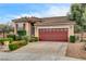 Single-story home with tile roof, desert landscaping, and a two-car garage with a row of windows at 3200 Ridgecliff St, Las Vegas, NV 89129