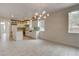 Open-concept kitchen featuring white cabinets, an island, and stylish backsplash at 3200 Ridgecliff St, Las Vegas, NV 89129