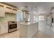 Bright kitchen with stainless appliances, island, and tile backsplash at 3200 Ridgecliff St, Las Vegas, NV 89129