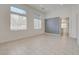 Bright living room with decorative accent wall and tile floors at 3200 Ridgecliff St, Las Vegas, NV 89129