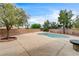 Backyard pool with concrete patio, surrounded by brick walls and lush trees at 3200 Ridgecliff St, Las Vegas, NV 89129