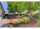 Landscaped backyard featuring a pergola, bistro set, and established trees, ideal for outdoor living at 3913 Cutting Horse Ave, North Las Vegas, NV 89032