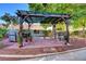 Charming backyard featuring a pergola with an outdoor kitchen and seating area at 3913 Cutting Horse Ave, North Las Vegas, NV 89032