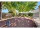 Serene backyard featuring mature trees, garden landscaping and a cozy seating area at 3913 Cutting Horse Ave, North Las Vegas, NV 89032
