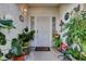 Inviting front porch featuring a decorative security door and an array of potted plants at 3913 Cutting Horse Ave, North Las Vegas, NV 89032