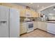 Well-lit kitchen featuring white appliances, granite countertops, and ample storage space at 3913 Cutting Horse Ave, North Las Vegas, NV 89032