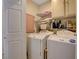 Laundry room with a washer, dryer, and shelving for storage at 3913 Cutting Horse Ave, North Las Vegas, NV 89032