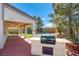 Outdoor kitchen area with a grill and covered patio overlooking the pool at 3953 Broad Meadow Ct, Las Vegas, NV 89129