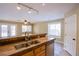 Open concept kitchen with a breakfast bar overlooking the living area at 3953 Broad Meadow Ct, Las Vegas, NV 89129