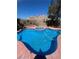 Backyard pool with hot tub, landscaping, and partial mountain view at 3953 Broad Meadow Ct, Las Vegas, NV 89129