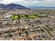 Expansive aerial view of a residential area with mountain backdrop and city skyline, offering scenic neighborhood charm at 423 Golden Valley Dr, Henderson, NV 89002