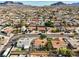Extensive aerial view of houses within a mature residential area, complete with mountain views at 423 Golden Valley Dr, Henderson, NV 89002