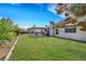 Lush backyard featuring a manicured lawn and covered patio area at 423 Golden Valley Dr, Henderson, NV 89002