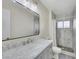 A well-lit bathroom with a marble vanity, a modern shower, and stylish fixtures at 423 Golden Valley Dr, Henderson, NV 89002