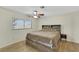 A cozy bedroom featuring a comfortable bed, natural light, and a ceiling fan at 423 Golden Valley Dr, Henderson, NV 89002