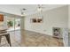A sunlit dining area adjacent to the kitchen, featuring a ceiling fan and backyard access at 423 Golden Valley Dr, Henderson, NV 89002