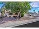 Single-Gathering home featuring desert landscaping, large shade tree, and a private driveway, offering a comfortable suburban lifestyle at 423 Golden Valley Dr, Henderson, NV 89002