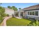 Backyard with synthetic grass, pergola, brick wall and landscaping at 423 Red Canvas Pl, Las Vegas, NV 89144