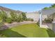Backyard featuring a brick wall, synthetic grass and covered patio at 423 Red Canvas Pl, Las Vegas, NV 89144