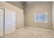 Neutral bedroom with carpet, window and closet with sliding doors at 423 Red Canvas Pl, Las Vegas, NV 89144