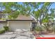 Charming home featuring a two-car garage, desert landscaping, and mature trees providing ample shade at 423 Red Canvas Pl, Las Vegas, NV 89144