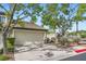 Charming home featuring a two-car garage, desert landscaping, and mature trees providing ample shade at 423 Red Canvas Pl, Las Vegas, NV 89144