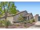Exterior view of the home featuring desert landscaping, a brick gate, and well-maintained grounds at 423 Red Canvas Pl, Las Vegas, NV 89144
