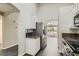 Kitchen view showcasing stainless steel appliances, granite countertops, and an open view into the living area at 423 Red Canvas Pl, Las Vegas, NV 89144