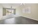 Spacious living room featuring neutral colors, a ceiling fan, and sliding glass doors leading to the backyard at 423 Red Canvas Pl, Las Vegas, NV 89144