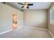 Spacious bedroom with neutral colors, carpet, and access to an ensuite bathroom featuring a luxurious tub and shower at 423 Red Canvas Pl, Las Vegas, NV 89144
