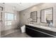 Sleek bathroom featuring double vanity, a spacious glass-enclosed shower, and modern fixtures, exuding sophistication at 4471 Dean Martin Dr # 1210, Las Vegas, NV 89103