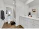 Bright bathroom featuring double sinks, a large mirror, and modern fixtures and decor at 5016 Kaslo Ave, Las Vegas, NV 89139