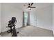 Bright bedroom with a ceiling fan, an exercise bike and a window at 5016 Kaslo Ave, Las Vegas, NV 89139