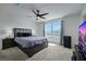 Comfortable bedroom featuring plush carpet, a modern ceiling fan, and plenty of natural light at 5016 Kaslo Ave, Las Vegas, NV 89139