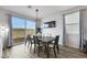 Dining area with sliding glass doors to the outside, modern light fixture, and seating for six at 5016 Kaslo Ave, Las Vegas, NV 89139